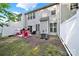 Cozy backyard with a patio, bordered by a white fence for privacy and relaxation at 10135 Blakeney Preserve Dr, Charlotte, NC 28277