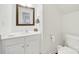Bathroom featuring a white vanity with decorative mirror and white toilet at 10135 Blakeney Preserve Dr, Charlotte, NC 28277