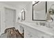 Bathroom featuring double vanity with white countertops and dark wood-look flooring at 10135 Blakeney Preserve Dr, Charlotte, NC 28277