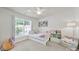 Charming bedroom with a trundle bed, ceiling fan, and a view from a large window at 10135 Blakeney Preserve Dr, Charlotte, NC 28277