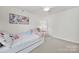 Bright bedroom with light walls, a cozy trundle bed, ceiling fan, and closet at 10135 Blakeney Preserve Dr, Charlotte, NC 28277