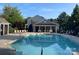 A community pool with comfortable lounge chairs and seating under a bright, sunny sky at 10135 Blakeney Preserve Dr, Charlotte, NC 28277