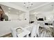 Open concept dining room with white table, seating for six, and hardwood flooring at 10135 Blakeney Preserve Dr, Charlotte, NC 28277