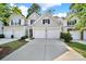 Exterior view featuring multiple homes with garages and well-kept lawns at 10135 Blakeney Preserve Dr, Charlotte, NC 28277