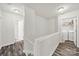 Upstairs hallway with hardwood floors and a laundry closet with a washer and dryer at 10135 Blakeney Preserve Dr, Charlotte, NC 28277
