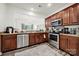 Kitchen with stainless steel appliances, wood cabinets and view to dining room at 10135 Blakeney Preserve Dr, Charlotte, NC 28277