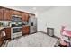 The kitchen features stainless steel appliances and dark wood cabinets at 10135 Blakeney Preserve Dr, Charlotte, NC 28277