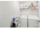 Functional laundry room with washer, dryer, and shelving for storage at 10135 Blakeney Preserve Dr, Charlotte, NC 28277