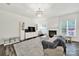 Bright living room featuring hardwood floors, fireplace, and natural light at 10135 Blakeney Preserve Dr, Charlotte, NC 28277