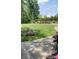 A serene park setting with lush greenery, walking paths, and flower beds at 10135 Blakeney Preserve Dr, Charlotte, NC 28277