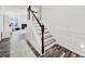 Beautiful staircase featuring wooden treads, white risers, and decorative wall molding at 10135 Blakeney Preserve Dr, Charlotte, NC 28277