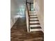Hallway with wooden-tread staircase showcasing wainscoting wall trim and natural light at 10135 Blakeney Preserve Dr, Charlotte, NC 28277