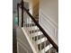 Staircase with wooden handrail and steps leading to the second floor at 10135 Blakeney Preserve Dr, Charlotte, NC 28277