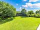 Expansive backyard features lush green grass, mature trees and a privacy fence at 1016 Yellow Daisy Dr, Matthews, NC 28104
