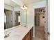 Bright bathroom features a long vanity with double sinks and a large mirror reflecting into a bedroom at 1016 Yellow Daisy Dr, Matthews, NC 28104
