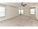 Large bedroom boasts neutral walls and carpeting, a tray ceiling, and a ceiling fan at 1016 Yellow Daisy Dr, Matthews, NC 28104