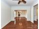 Elegant dining room with hardwood floors, crown molding, and a view into the kitchen at 1016 Yellow Daisy Dr, Matthews, NC 28104