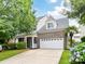Charming two-story home features a brick facade, well-manicured lawn, and a spacious two-car garage at 1016 Yellow Daisy Dr, Matthews, NC 28104