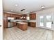 Spacious kitchen features a center island, stainless steel appliances, and access to outdoor patio at 1016 Yellow Daisy Dr, Matthews, NC 28104