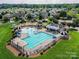 Aerial view of the community pool, playground, and surrounding neighborhood homes at 1016 Yellow Daisy Dr, Matthews, NC 28104