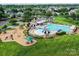 Aerial view of community pool and playground featuring lounge chairs and shaded seating at 1016 Yellow Daisy Dr, Matthews, NC 28104