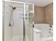 Beautiful glass-enclosed shower features a handheld shower head and built-in shelving at 1016 Yellow Daisy Dr, Matthews, NC 28104