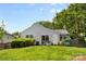 Serene backyard showcasing a patio, lush lawn, and carefully manicured greenery at 10621 Glenmac Rd, Charlotte, NC 28215
