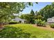 Backyard view with lush lawn and mature trees, offering privacy at 10621 Glenmac Rd, Charlotte, NC 28215