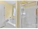 Bathroom featuring soaking tub and glass shower at 10621 Glenmac Rd, Charlotte, NC 28215