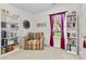 Bright bedroom featuring built-in bookshelves, comfortable seating and a window at 10621 Glenmac Rd, Charlotte, NC 28215