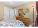 This primary bedroom features a traditional wooden dresser and a window at 10621 Glenmac Rd, Charlotte, NC 28215