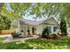 Charming single-story home featuring a cozy front porch with seating and lush landscaping at 10621 Glenmac Rd, Charlotte, NC 28215