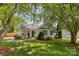 Inviting single-story home with well-maintained lawn, front porch seating, and mature shade trees at 10621 Glenmac Rd, Charlotte, NC 28215