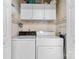 Laundry room features a washer, dryer, and overhead cabinets for storage at 10621 Glenmac Rd, Charlotte, NC 28215