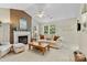 Cozy living room features a fireplace, large windows, and neutral decor at 10621 Glenmac Rd, Charlotte, NC 28215