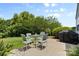 Outdoor patio featuring a dining table, four chairs, and a grill at 10621 Glenmac Rd, Charlotte, NC 28215