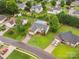 Aerial view showcases this house in a beautiful neighborhood with pools and well manicured lawns at 116 Birchwood Ct, Mount Holly, NC 28120