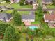 Aerial view of the backyard with a pool, deck, and large, shady trees providing ample privacy at 116 Birchwood Ct, Mount Holly, NC 28120