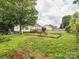 Spacious backyard featuring a wooden deck and a quaint picnic area, perfect for outdoor entertaining at 116 Birchwood Ct, Mount Holly, NC 28120