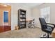 Carpeted bedroom with a built-in bookcase, desk, and view into another bedroom at 116 Birchwood Ct, Mount Holly, NC 28120