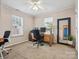 Carpeted bedroom with dual windows, a desk, and a full-length mirror at 116 Birchwood Ct, Mount Holly, NC 28120