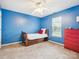 Cozy bedroom with blue walls, carpet, and a ceiling fan and wood bed at 116 Birchwood Ct, Mount Holly, NC 28120