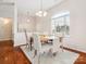 Bright dining area with hardwood floors, large window, modern chandelier and neutral paint at 116 Birchwood Ct, Mount Holly, NC 28120