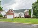 Well-maintained single Gathering home with attached two car garage, manicured lawn, and brick accents at 116 Birchwood Ct, Mount Holly, NC 28120