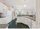 Bright kitchen with white cabinets and a view of the dining area at 116 Birchwood Ct, Mount Holly, NC 28120