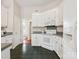 Bright kitchen with white appliances and black tiled floor at 116 Birchwood Ct, Mount Holly, NC 28120