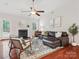 Comfortable living room features a fireplace, hardwood floors, high ceilings, and access to outdoor patio at 116 Birchwood Ct, Mount Holly, NC 28120