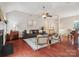 Spacious living room boasts a high ceiling, hardwood floors, comfortable seating and natural light at 116 Birchwood Ct, Mount Holly, NC 28120
