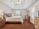 Spacious main bedroom with tray ceilings, hardwood floors, and bright natural light at 116 Birchwood Ct, Mount Holly, NC 28120