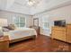 Comfortable main bedroom with hardwood floors, a ceiling fan, and bright natural light at 116 Birchwood Ct, Mount Holly, NC 28120